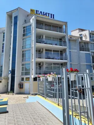 an apartment building with flowers in the balconies at Апартамент Бриджит Слънчев бряг in Sunny Beach