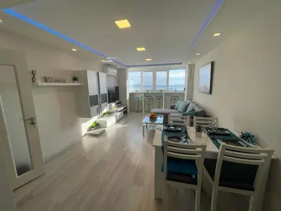 a kitchen and living room with a blue ceiling at Апартамент Панорама Славейков in Burgas City