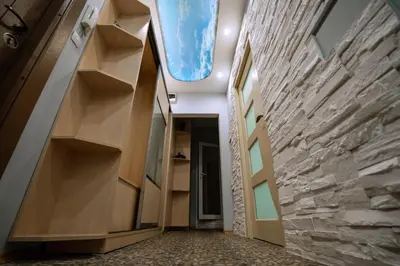 a hallway in a building with a stone wall at Seaside Apartament in Burgas City