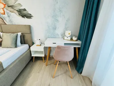 a bedroom with a bed and a desk with a chair at PARADISO 'В' - 107 Panoramic Sea View Large STUDIO Nessebar in Nesebar
