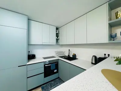 a white kitchen with white cabinets and appliances at PARADISO 'В' - 107 Panoramic Sea View Large STUDIO Nessebar in Nesebar