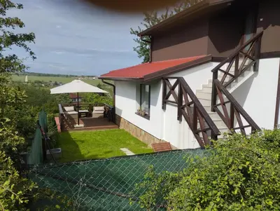 an external view of a house with a fence at Горе на вилата in Shkorpilovtsi