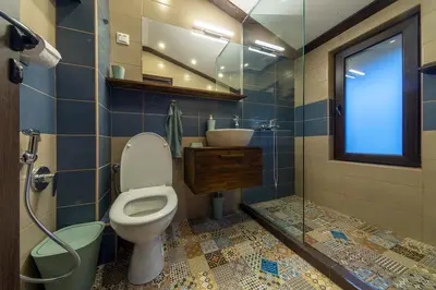 a bathroom with a toilet and a sink and a window at Горе на вилата in Shkorpilovtsi