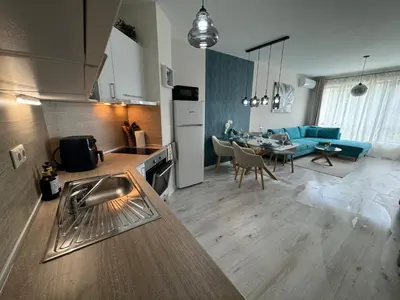 a kitchen and living room with a table and a couch at Elizi summer house in Varna South Bay Beach in Varna City