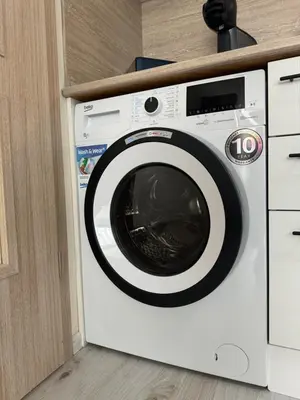 a white washing machine sitting in a kitchen at Elizi summer house in Varna South Bay Beach in Varna City