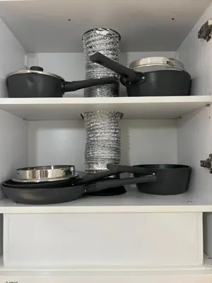 two pots and pans on shelves in a kitchen at Elizi summer house in Varna South Bay Beach in Varna City