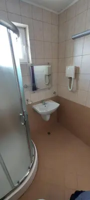 a bathroom with a sink and a shower at Семеен Хотел ''Кораб Ренеса'' in Ravda