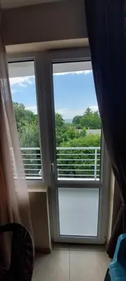 a window in a room with a view of a balcony at Семеен Хотел ''Кораб Ренеса'' in Ravda