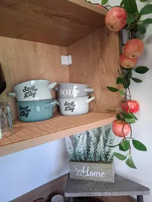 a shelf with two cups and a plant on it at LaRenta Стилни апартаменти с 2 спални и гледка море в Свети Влас in Sveti Vlas