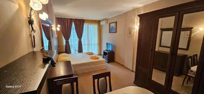 a room with a bedroom with a bed and a window at Частно студио в комплекс Поморие Ризорт in Pomorie
