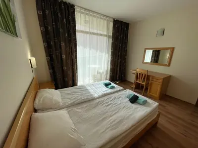 a small bedroom with a bed and a window at Grenada - Apartments by the beach in Sunny Beach