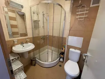 a bathroom with a shower and a toilet and a sink at Royal Sun - Premium Apartments in Sunny Beach