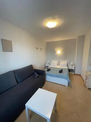 a living room with a couch and a bed at Royal Sun - Premium Apartments in Sunny Beach