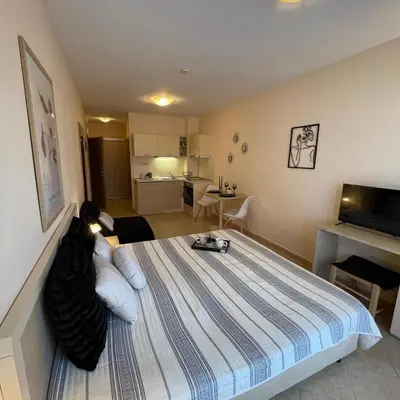 a bedroom with a bed and a living room at Royal Sun - Premium Apartments in Sunny Beach
