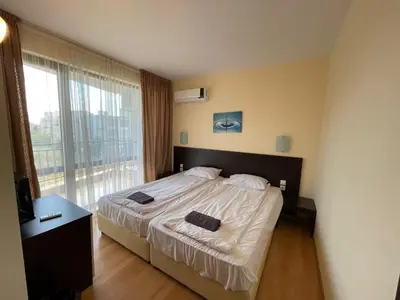 a bedroom with a bed and a large window at Macon Residence - Premium Apartments in Sveti Vlas