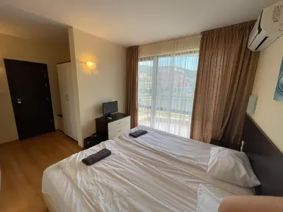 a bedroom with a bed with two black objects on it at Macon Residence - Premium Apartments in Sveti Vlas