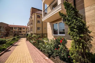a brick walkway in front of a building with flowers at Macon Residence - Premium Apartments in Sveti Vlas
