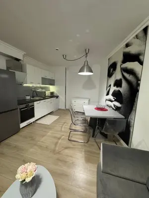 a living room with a table and a kitchen at Gold Coast SP apartments in Burgas City