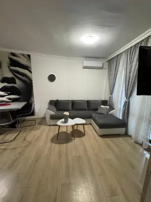 a living room with a couch and a table at Gold Coast SP apartments in Burgas City
