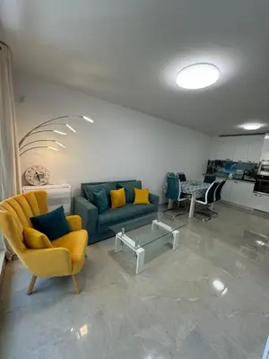 a living room with a couch and chairs and a table at Gold Coast SP apartments in Burgas City