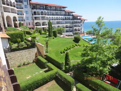 a view of a garden in front of a building at MONASTERY Seafront Apartments in Sveti Vlas