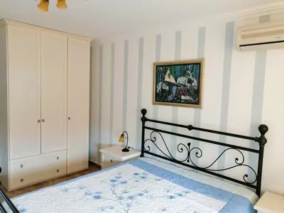 a bedroom with a bed in a room with striped walls at MONASTERY Seafront Apartments in Sveti Vlas