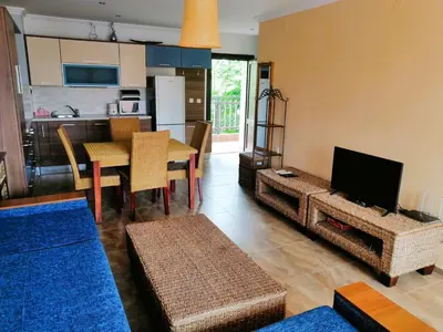 a living room with a kitchen and a dining room at MONASTERY Seafront Apartments in Sveti Vlas