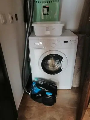 a washing machine in a bathroom with a vacuum at MONASTERY Seafront Apartments in Sveti Vlas