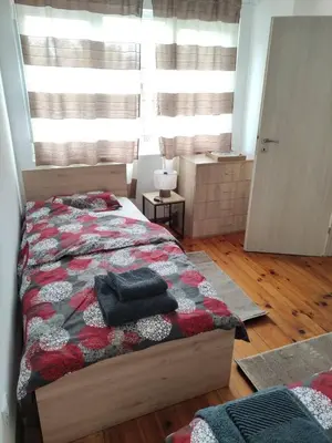 a bedroom with a bed and a large window at rozi in Burgas City