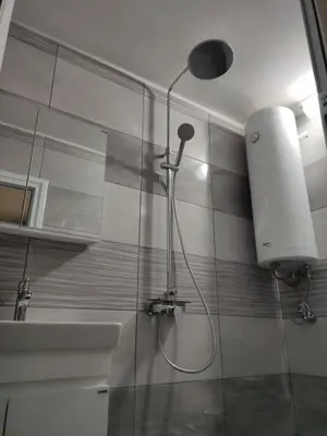 a shower in a bathroom with a shower head at rozi in Burgas City