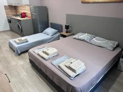 a room with two beds with towels on them at Студио Комфорт Бургас Център in Burgas City