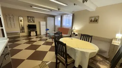 a living room with a table and a checkered floor at Spacious Apartment in Central Burgas in Burgas City
