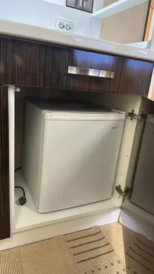 a closet with a white door in a cabinet at Spacious Apartment in Central Burgas in Burgas City