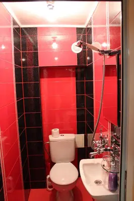 a red bathroom with a toilet and a sink at Spacious Apartment in Central Burgas in Burgas City