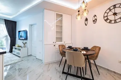 a dining room with a table and chairs at Boutique 1 bedroom apartment with Private Parking and Port View in Varna City