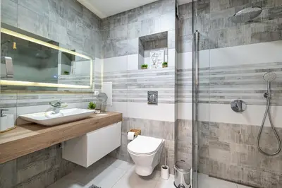 a bathroom with a shower and a toilet and a sink at Boutique 1 bedroom apartment with Private Parking and Port View in Varna City