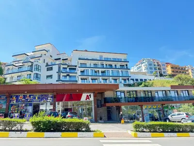 a large building with a parking lot in front of it at Sea la Vie in Sozopol