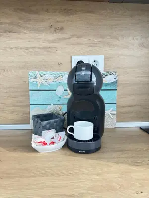 a coffee maker sitting on the floor with a cup at Wave & Sea in Sozopol