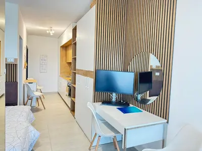 a room with a desk with a computer on a wall at Wave & Sea in Sozopol