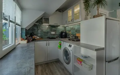 a kitchen with a refrigerator and a washer and dryer at Bella in Nesebar