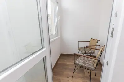 a hallway with two chairs and a window at The Central House 1 in Burgas City