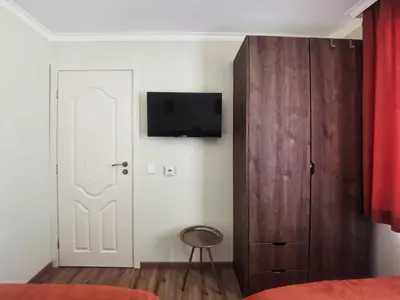a bedroom with a white door and a tv on the wall at Timeless Sea in Tsarevo