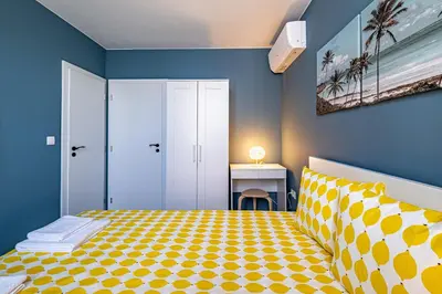 a bedroom with a bed with a yellow and blue at Apartment Linda Cosy Getaway in Varna City