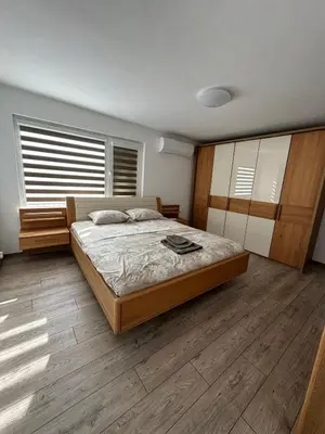 a bedroom with a large bed and wooden floors at Victoria in Varna City