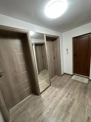 an empty room with three doors and wooden floors at Victoria in Varna City
