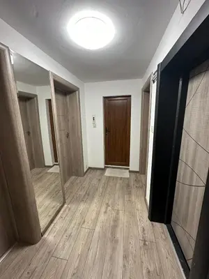 an empty room with a hallway with wooden floors and a door at Victoria in Varna City