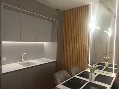 a kitchen with a table with chairs and a sink at Tranquilo Escapes in Sunny Beach