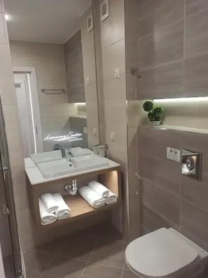 a bathroom with a sink and a toilet and a mirror at Tranquilo Escapes in Sunny Beach