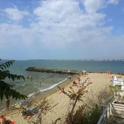 a group of people swimming in the water at a beach at Helios Seaview Apartment in Sveti Vlas