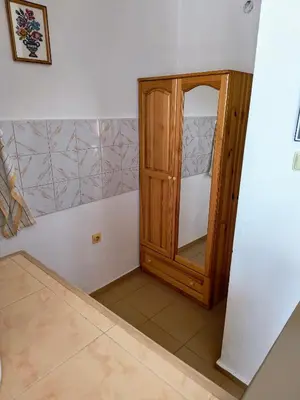 a bathroom with a wooden cabinet in a room at Вила Катажина - Villa Katarzyna in Sozopol